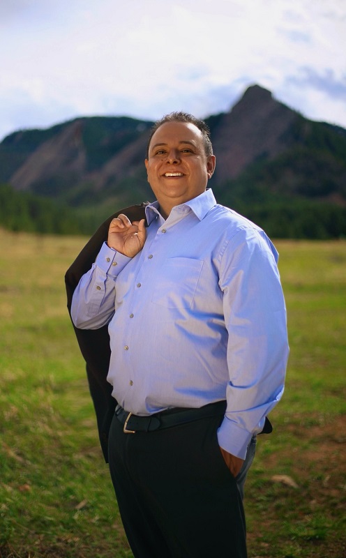 a man standing on top of a grass covered field