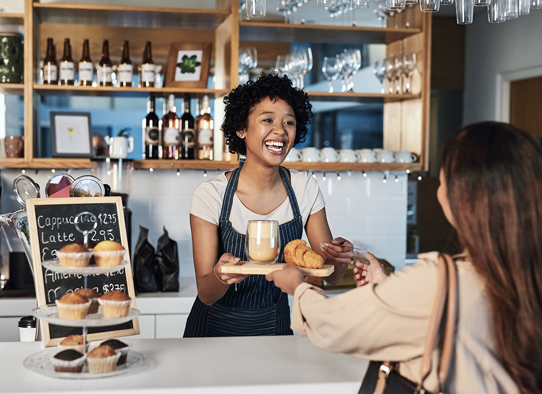 We Are Independent - Friendly Cafe Worker Serving a Customer